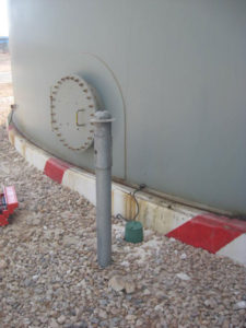 Hot dip galvanized test station for a storage tank bottom
