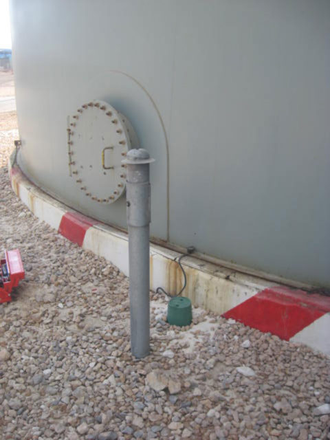 Hot dip galvanized test station for a storage tank bottom